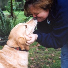 Janet Berwick getting kisses from her dog