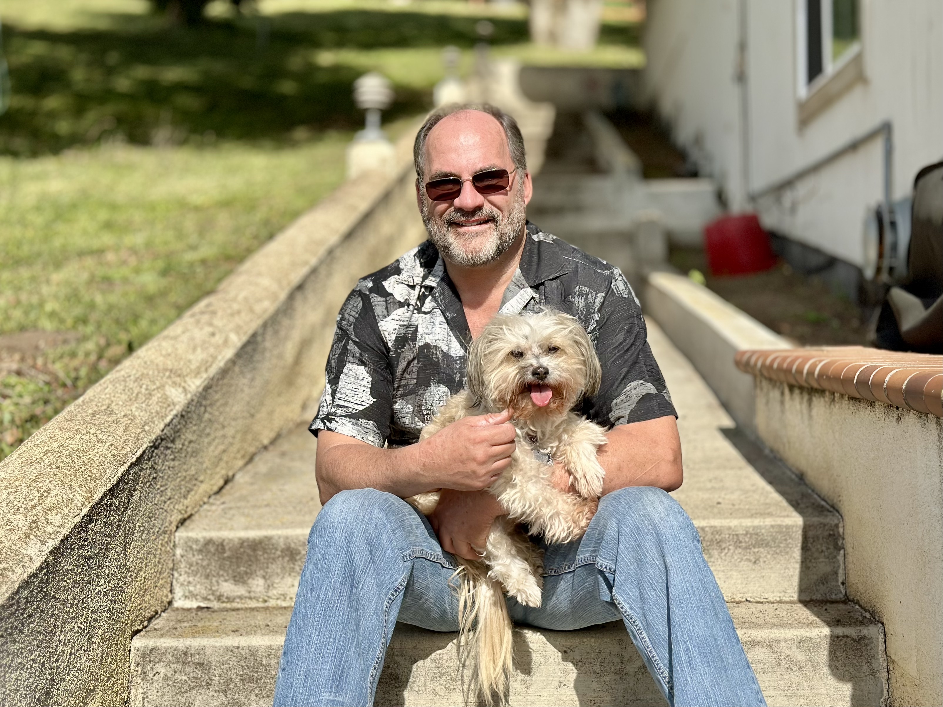 Highway and his person White dog and a man sitting together