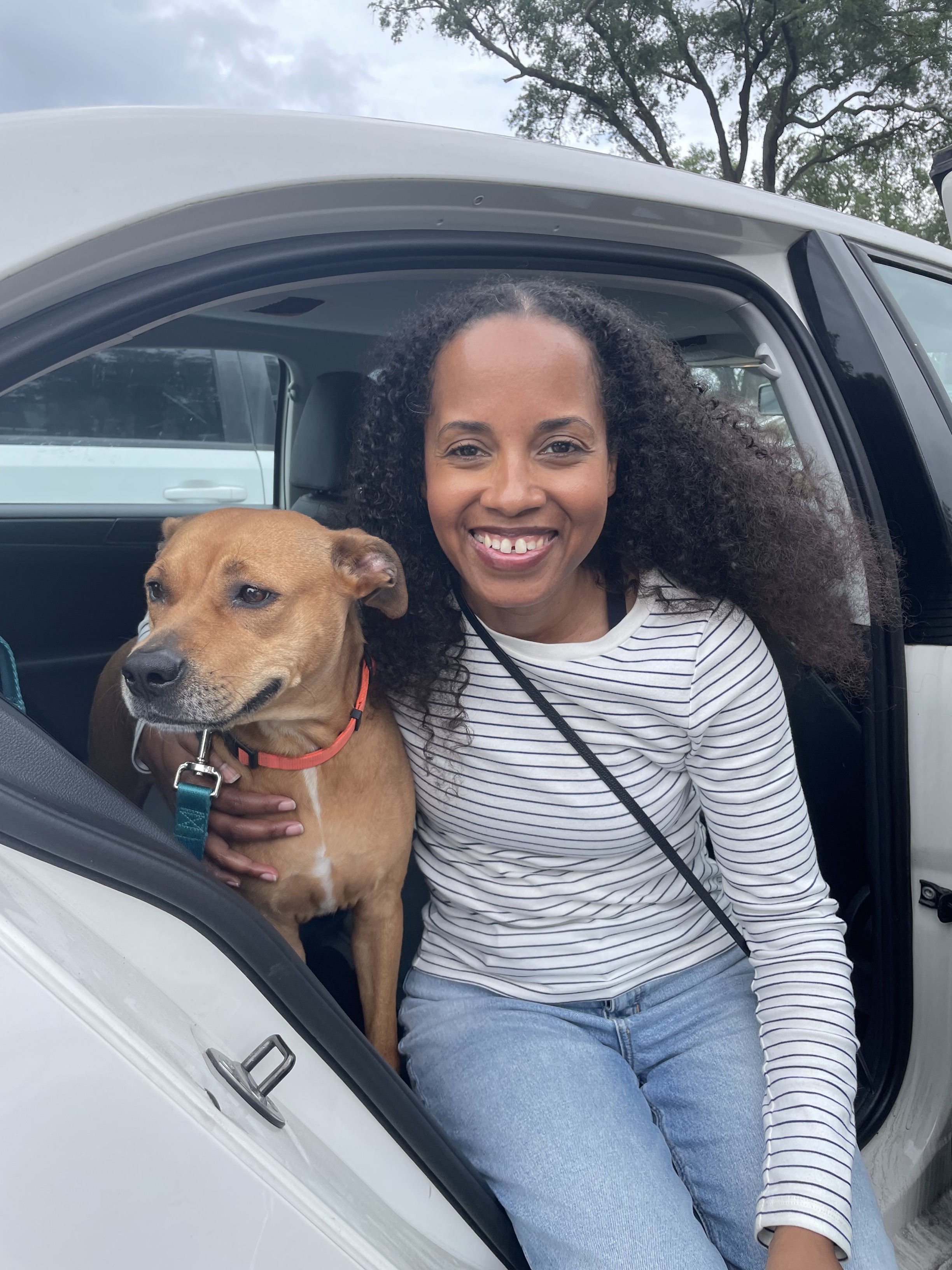 Vonna and her person in the car woman and dog in car with open door