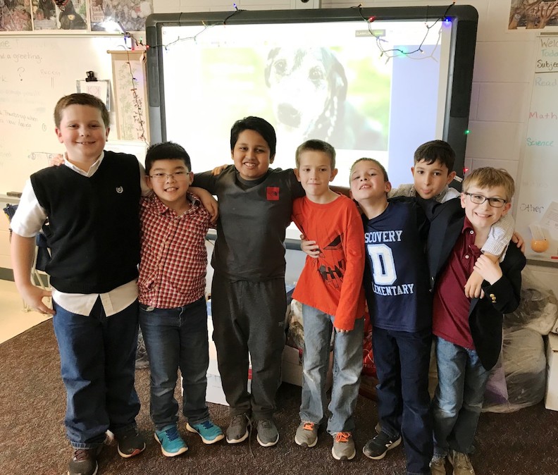 Discovery Elementary students Seven third grade boys standing arm and arm
