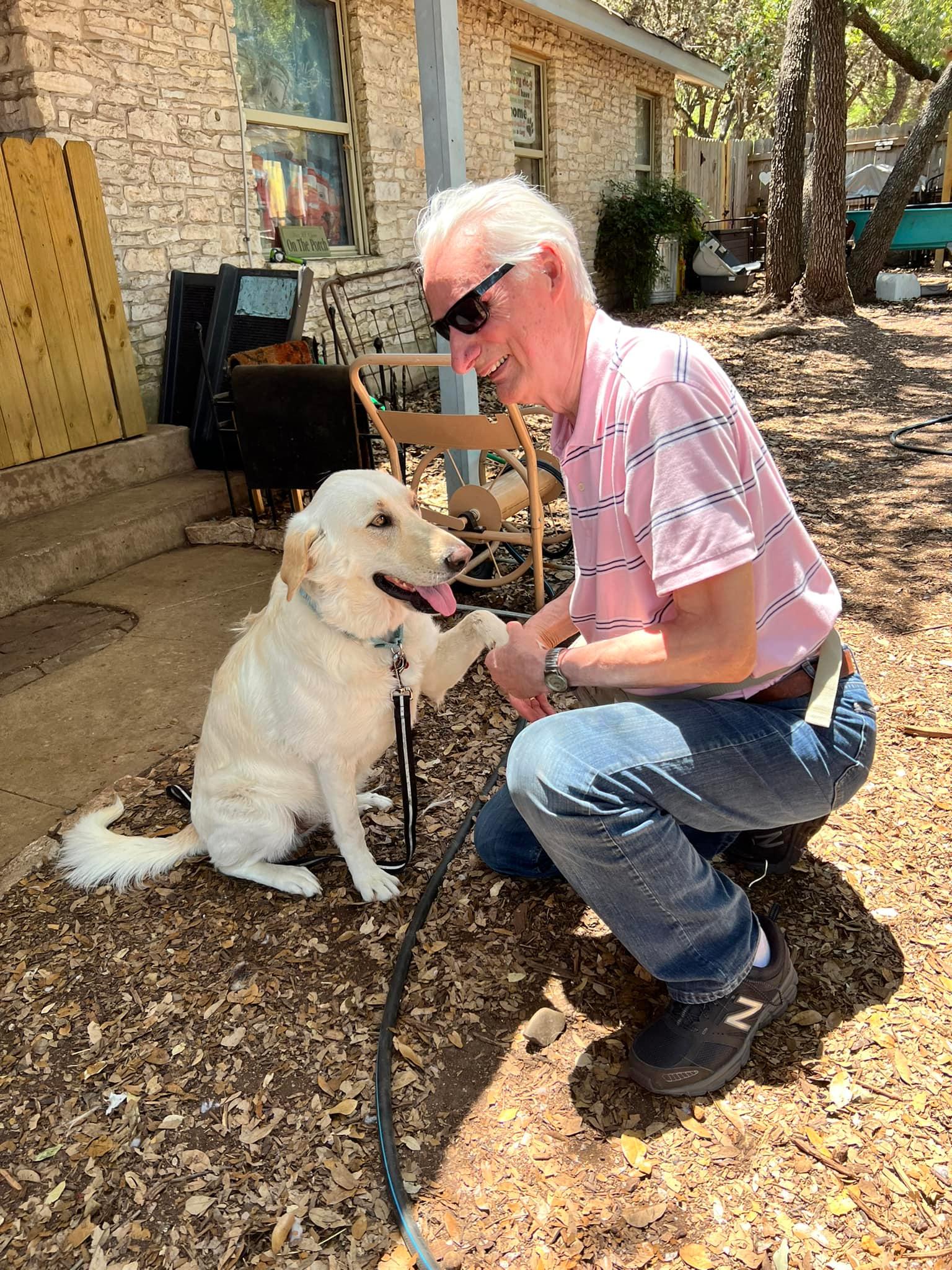 Larry and Calli shake hands/ paws dog and man shaking hand/ paw