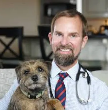 Dr. Ernie Ward with dog brown haired male doctor with dog