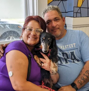 Ozzie with his people Dachshund with two people