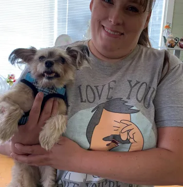 dog and his mom smiling