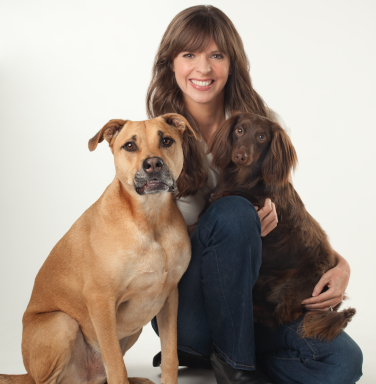 brown haired woman with two dogs