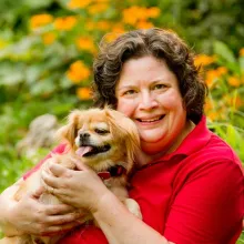 Julie Dudley holding her little dog