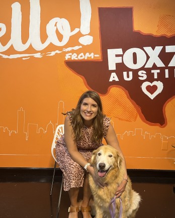 dog and woman in front of Texas wall