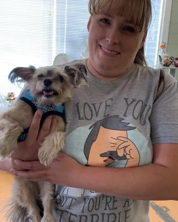 dog and his mom smiling